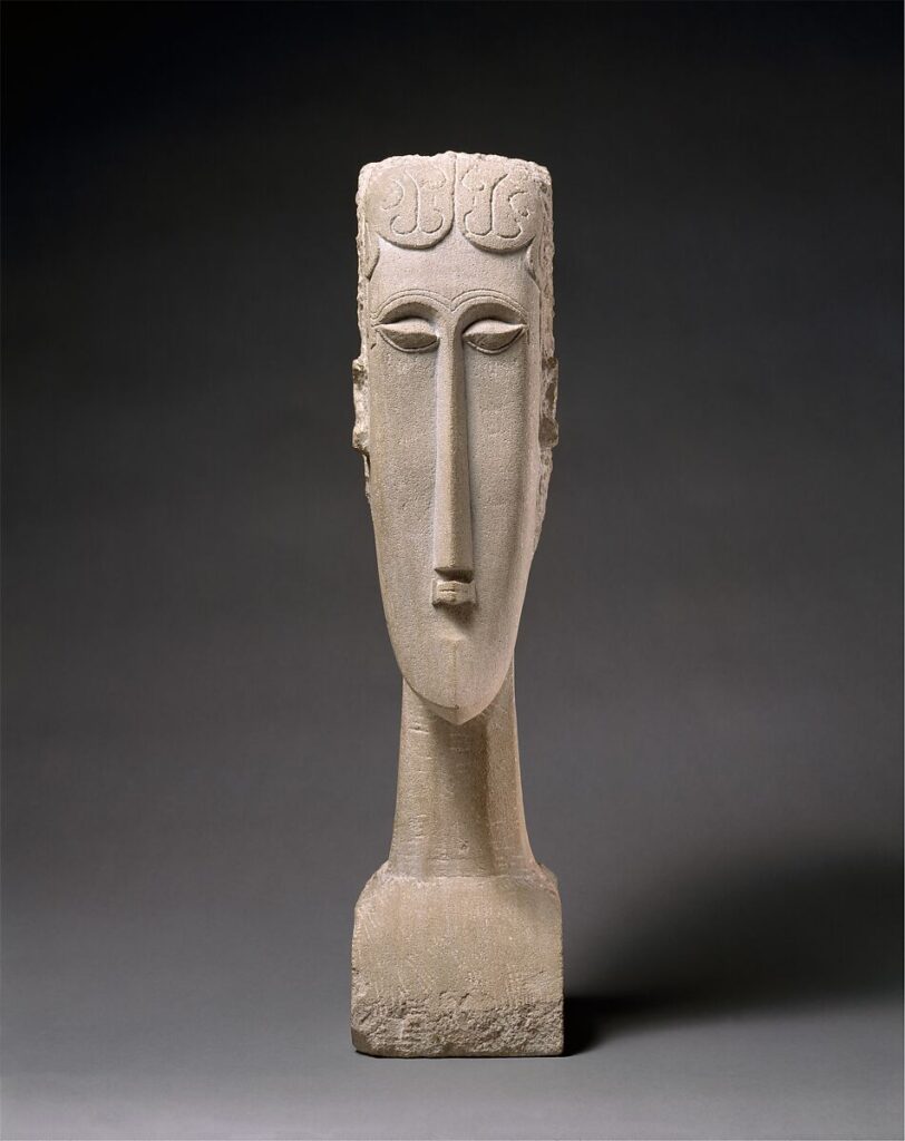 Tête, a limestone sculpture featuring an elongated head with stylized features, influenced by African and ancient art.